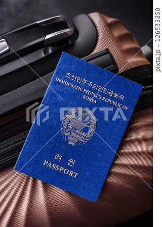International passport of a citizen of North Korea on a suitcase International passport of a citizen of North Korea on a suitcase 126535850