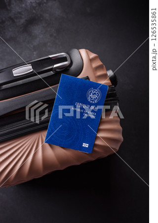 International passport of a citizen of South Korea on a suitcase International passport of a citizen of South Korea on a suitcase 126535861