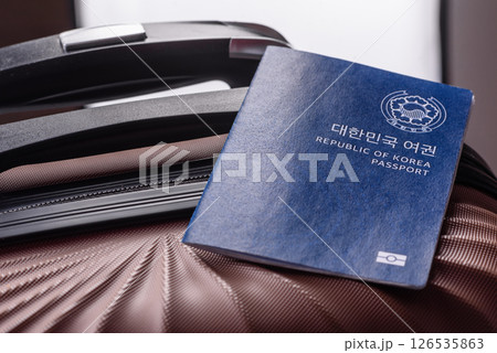 International passport of a citizen of South Korea on a suitcase International passport of a citizen of South Korea on a suitcase 126535863