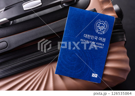 International passport of a citizen of South Korea on a suitcase International passport of a citizen of South Korea on a suitcase 126535864