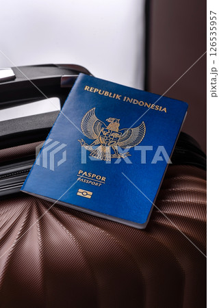 International passport of a citizen of Indonesia on a suitcase International passport of a citizen of Indonesia on a suitcase 126535957