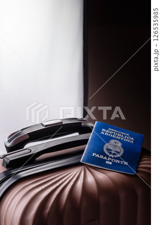 International passport of a citizen of Argentina on a suitcase 126535985