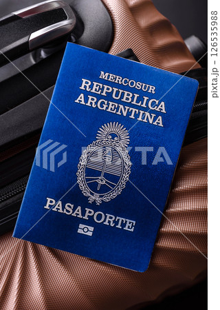 International passport of a citizen of Argentina on a suitcase 126535988