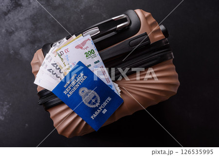 International passport of a citizen of Argentina on a suitcase 126535995