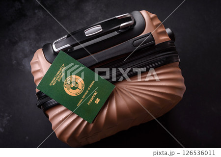 International passport of a citizen of Nigeria on a suitcase 126536011