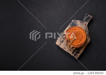 Round puff pastry croissant with pistachio filling or new york roll 126536030