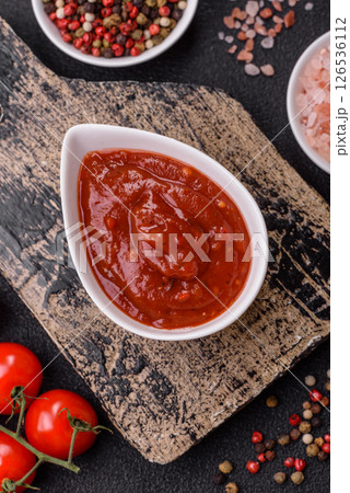 Red sauce or ketchup with salt and spices in ceramic sauce boat Red sauce or ketchup with salt and spices in ceramic sauce boat 126536112