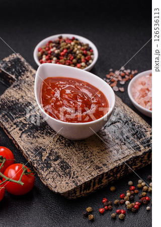 Red sauce or ketchup with salt and spices in ceramic sauce boat Red sauce or ketchup with salt and spices in ceramic sauce boat 126536113