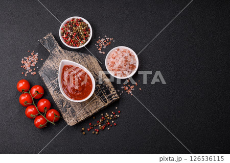 Red sauce or ketchup with salt and spices in ceramic sauce boat 126536115