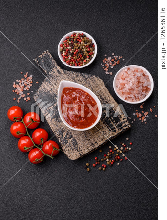 Red sauce or ketchup with salt and spices in ceramic sauce boat 126536116
