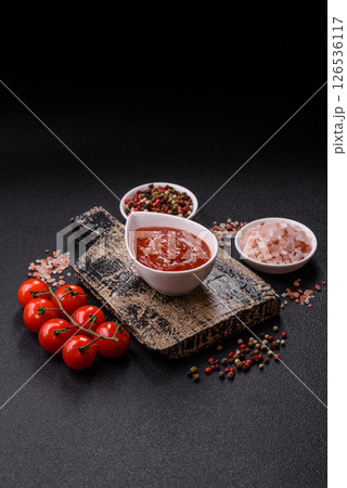 Red sauce or ketchup with salt and spices in ceramic sauce boat 126536117