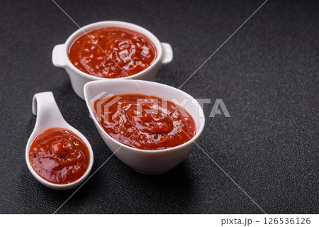 Red sauce or ketchup with salt and spices in ceramic sauce boat 126536126