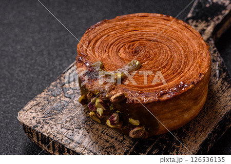 Round puff pastry croissant with pistachio filling or new york roll 126536135