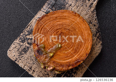 Round puff pastry croissant with pistachio filling or new york roll 126536136