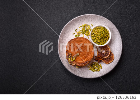 Round puff pastry croissant with pistachio filling or new york roll 126536162
