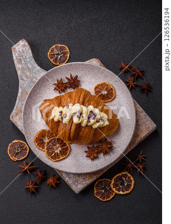 Sweet crispy fresh croissant with berry filling Sweet crispy fresh croissant with berry filling 126536194