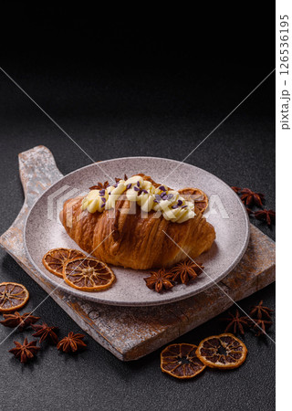 Sweet crispy fresh croissant with berry filling 126536195