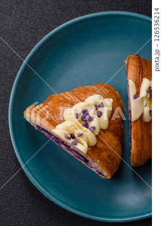 Sweet crispy fresh croissant with berry filling Sweet crispy fresh croissant with berry filling 126536214