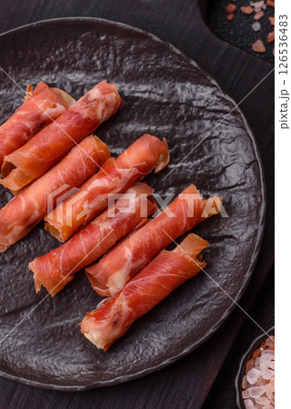Cheese and meat, jamon or prosciutto rolled into a roll Cheese and meat, jamon or prosciutto rolled into a roll 126536483