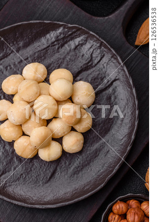 Raw peeled macadamia nut in ceramic bowl Raw peeled macadamia nut in ceramic bowl 126536538