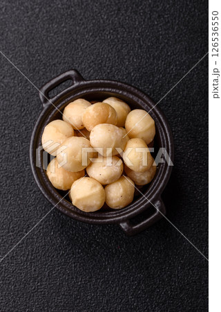 Raw peeled macadamia nut in ceramic bowl Raw peeled macadamia nut in ceramic bowl 126536550