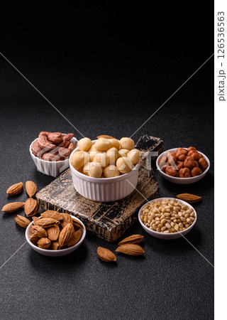 Raw peeled macadamia nut in ceramic bowl 126536563