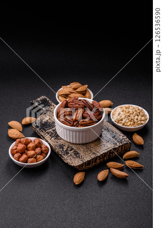 Nut, pecans in a ceramic bowl, an ingredient in vegan food 126536590