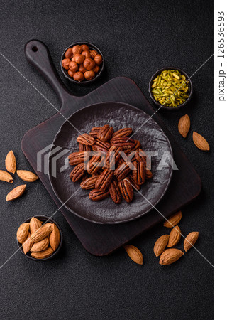 Nut, pecans in a ceramic bowl, an ingredient in vegan food 126536593