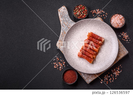 Cheese and meat, jamon or prosciutto rolled into a roll Cheese and meat, jamon or prosciutto rolled into a roll 126536597