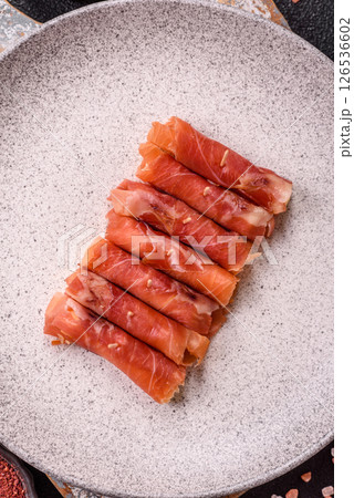 Cheese and meat, jamon or prosciutto rolled into a roll 126536602