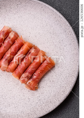 Cheese and meat, jamon or prosciutto rolled into a roll Cheese and meat, jamon or prosciutto rolled into a roll 126536606