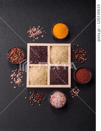 White and red raw rice grains in a ceramic bowl. Rice as an ingredient 126536619