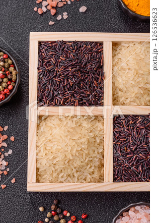 White and red raw rice grains in a ceramic bowl. Rice as an ingredient 126536623