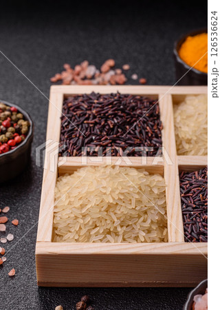 White and red raw rice grains in a ceramic bowl. Rice as an ingredient 126536624