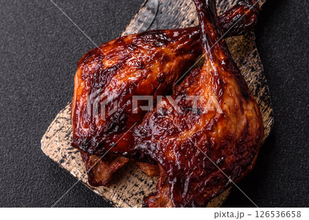 Duck, chicken leg or thigh grilled on a dark concrete background 126536658