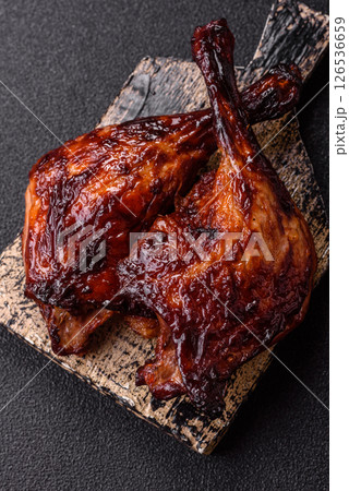 Duck, chicken leg or thigh grilled on a dark concrete background 126536659