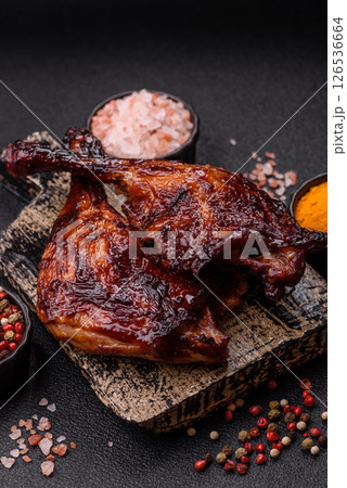 Duck, chicken leg or thigh grilled on a dark concrete background 126536664