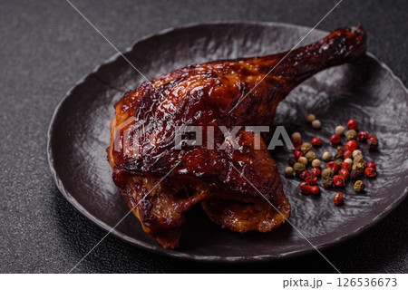Duck, chicken leg or thigh grilled on a dark concrete background 126536673