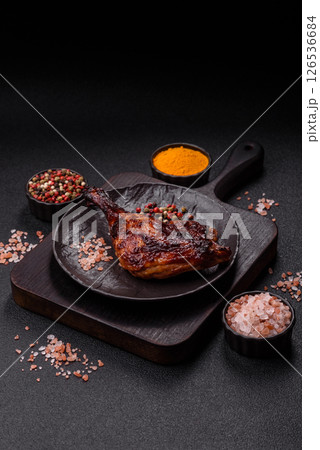Duck, chicken leg or thigh grilled on a dark concrete background Duck, chicken leg or thigh grilled on a dark concrete background 126536684