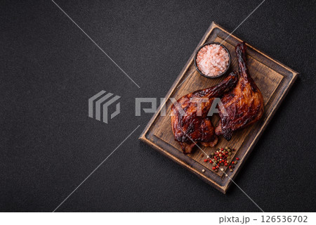 Duck, chicken leg or thigh grilled on a dark concrete background 126536702