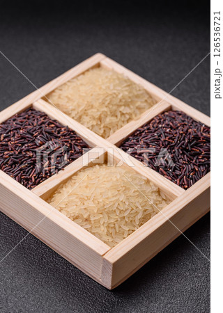 White and red raw rice grains in a ceramic bowl. Rice as an ingredient White and red raw rice grains in a ceramic bowl. Rice as an ingredient 126536721