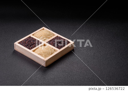 White and red raw rice grains in a ceramic bowl. Rice as an ingredient 126536722