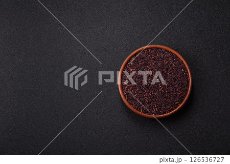 Red or brown raw rice in a ceramic bowl Red or brown raw rice in a ceramic bowl 126536727