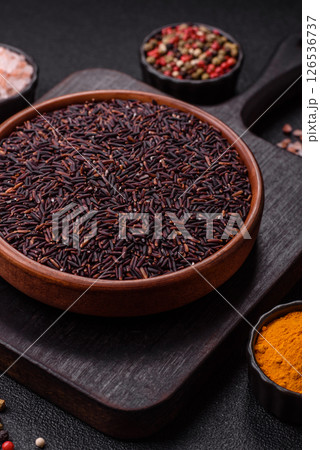 Red or brown raw rice in a ceramic bowl Red or brown raw rice in a ceramic bowl 126536737