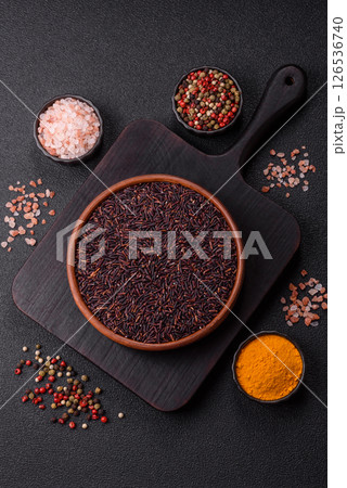 Red or brown raw rice in a ceramic bowl 126536740