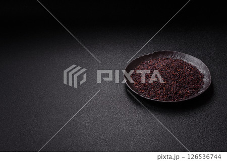 Red or brown raw rice in a ceramic bowl Red or brown raw rice in a ceramic bowl 126536744