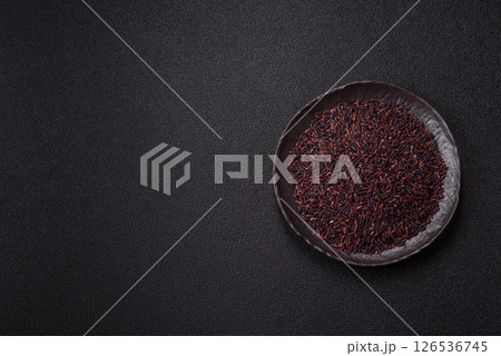 Red or brown raw rice in a ceramic bowl Red or brown raw rice in a ceramic bowl 126536745