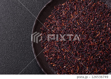 Red or brown raw rice in a ceramic bowl 126536749