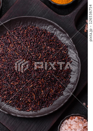 Red or brown raw rice in a ceramic bowl 126536754