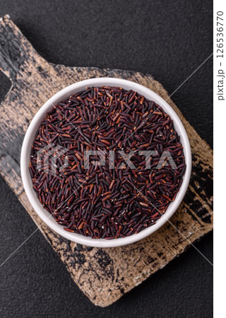 Red or brown raw rice in a ceramic bowl 126536770